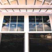White framed window under a porch roof with beams in Yorba Linda