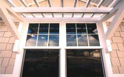 White framed window under a porch roof with beams in Yorba Linda