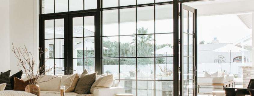 replacement doors Orange County, CA bright living room with black-framed glass patio doors