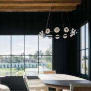 replacement windows Orange County, CA modern dining room with large black-framed windows