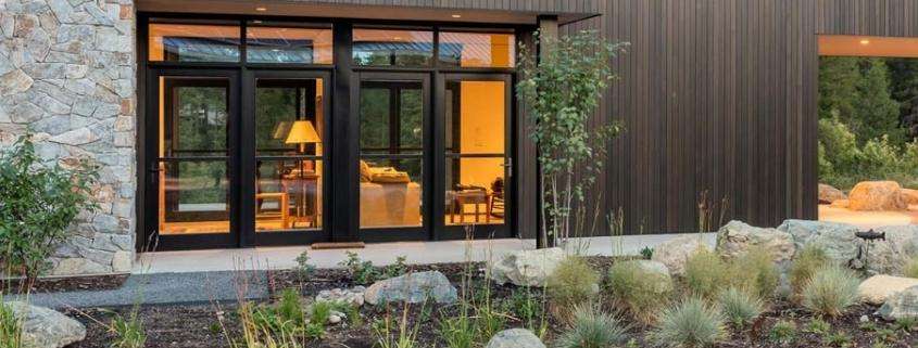 Modern home exterior featuring black-framed replacement doors in Yorba Linda, CA
