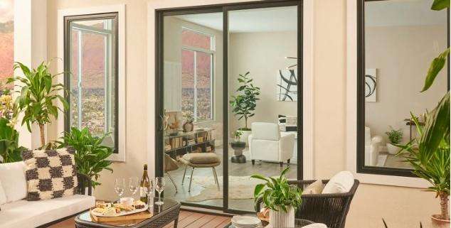 Modern black framed replacement doors in Yorba Linda, CA, opening to a bright outdoor patio