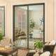 Modern black framed replacement doors in Yorba Linda, CA, opening to a bright outdoor patio