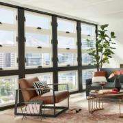 Replacement windows in Orange County, CA installed in a bright, modern living room with large energy-efficient windows.