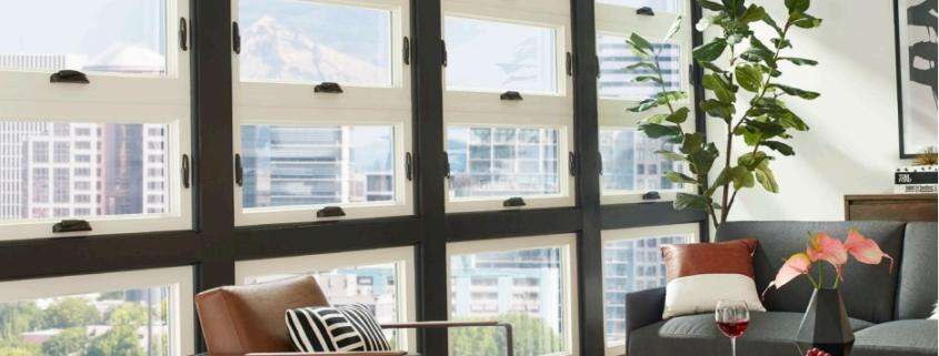 Replacement windows in Orange County, CA installed in a bright, modern living room with large energy-efficient windows.